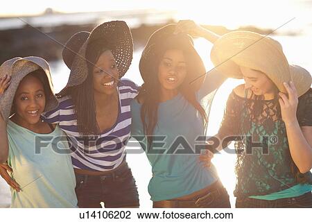 Women wearing sun hats on beach View Large Photo Image Stock Image - Women wearing sun hats on beach. Fotosearch