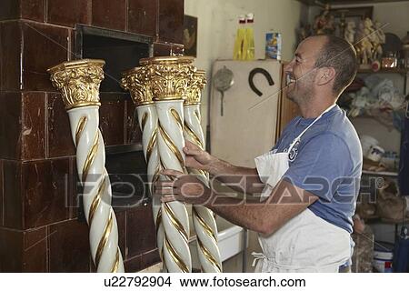 Worker admiring decorative poles View Large Photo Image Picture - Worker admiring decorative poles. Fotosearch