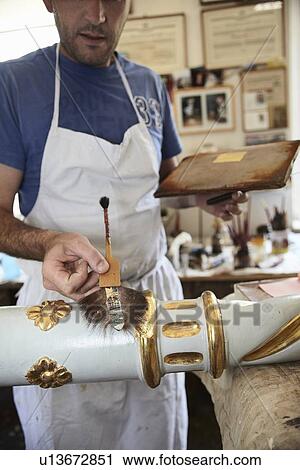 Worker applying gold leaf to pole View Large Photo Image Stock Image - Worker applying gold leaf to pole. Fotosearch