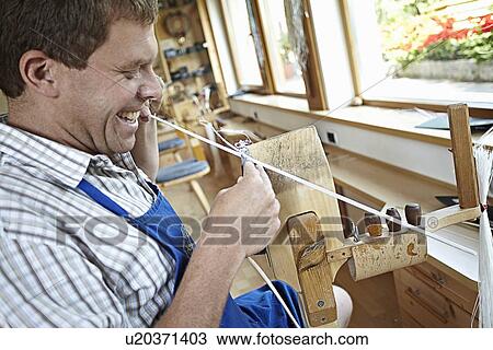 Worker laughing while weaving in shop View Large Photo Image Stock Image - Worker laughing while weaving in shop. Fotosearch