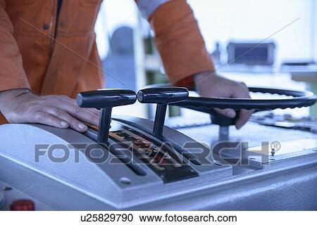 Worker manning tugboat controls View Large Photo Image Stock Image - Worker manning tugboat controls. Fotosearch