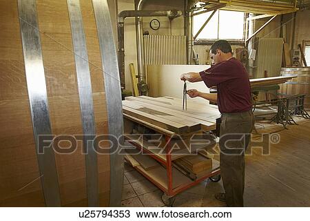Worker measuring wood in shop View Large Photo Image Stock Image - Worker measuring wood in shop. Fotosearch