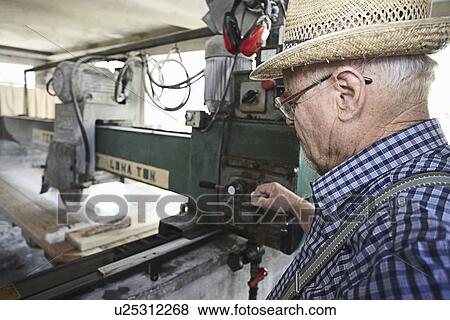 Worker using machinery to cut stone View Large Photo Image Stock Photo - Worker using machinery to cut stone. Fotosearch