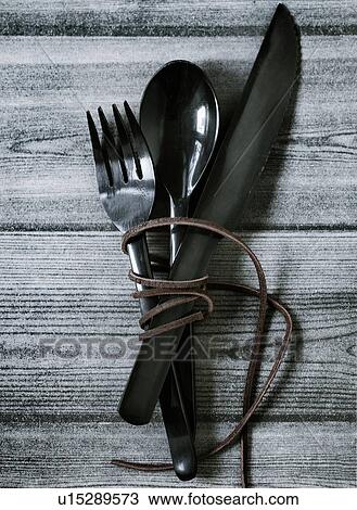 Wrapped cutlery on wooden table View Large Photo Image Stock Image - Wrapped cutlery on wooden table. Fotosearch