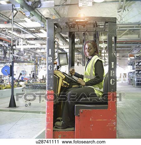 Apprentice lift operator in car factory View Large Photo Image Stock Image - Apprentice lift operator in car factory. Fotosearch