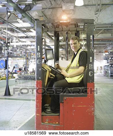 Apprentice lift operator in car factory View Large Photo Image Stock Photo - Apprentice lift operator in car factory. Fotosearch