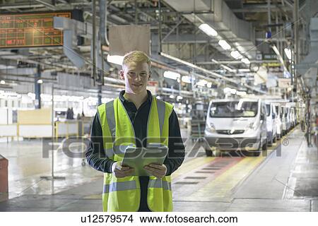Apprentice standing in car factory View Large Photo Image Picture - Apprentice standing in car factory. Fotosearch
