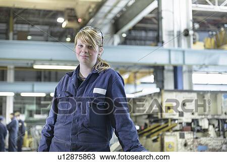 Apprentice standing in car factory View Large Photo Image Stock Image - Apprentice standing in car factory. Fotosearch
