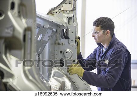 Stock Photography - Apprentice working in car factory. Fotosearch