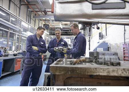 Apprentices learning in car factory View Large Photo Image Stock Image - Apprentices learning in car factory. Fotosearch