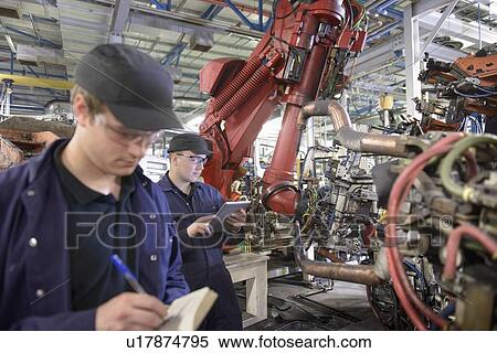 Apprentices with robots in car factory View Large Photo Image Stock Photography - Apprentices with robots in car factory. Fotosearch