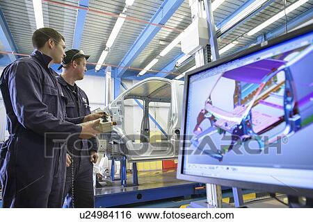 Stock Photograph - Apprentices working in car factory. Fotosearch