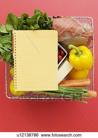 Stock Photograph - Basket with vegetables and notebook. Fotosearch