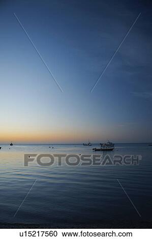 Boats sailing on calm water at sunset View Large Photo Image Stock Image - Boats sailing on calm water at sunset. Fotosearch