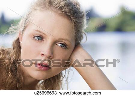 Bored woman resting head in hand View Large Photo Image Stock Image - Bored woman resting head in hand. Fotosearch