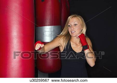 Boxer training with punching bag View Large Photo Image Stock Photo - Boxer training with punching bag. Fotosearch
