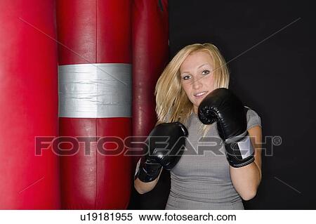 Stock Photography - Boxer training with punching bag. Fotosearch