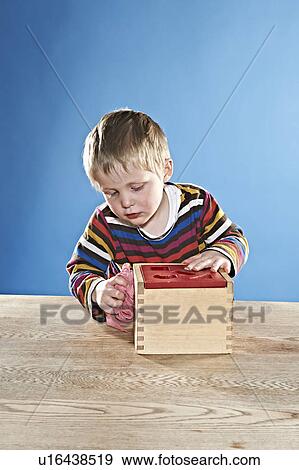 Boy cleaning wooden toy box View Large Photo Image Stock Photo - Boy cleaning wooden toy box. Fotosearch