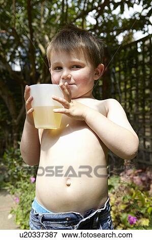 Boy drinking juice in garden View Large Photo Image Stock Photo - Boy drinking juice in garden. Fotosearch