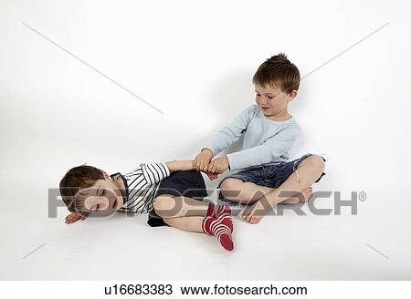 Boys playing together on floor View Large Photo Image Stock Image - Boys playing together on floor. Fotosearch