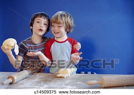 Stock Photography - Boys playing with dough. Fotosearch