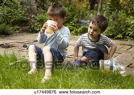 Stock Photograph - Boys relaxing in garden. Fotosearch