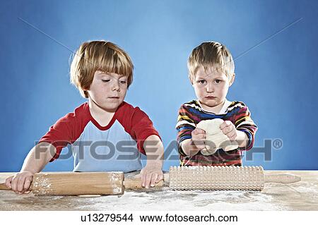 Boys rolling out dough View Large Photo Image Picture - Boys rolling out dough. Fotosearch