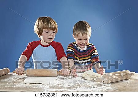Boys rolling out dough View Large Photo Image Stock Image - Boys rolling out dough. Fotosearch