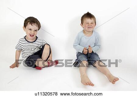 Boys smiling together on floor View Large Photo Image Stock Photo - Boys smiling together on floor. Fotosearch