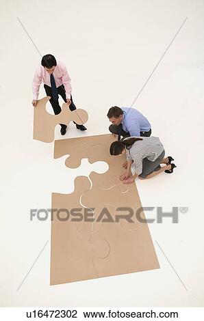 Business people assembling puzzle View Large Photo Image Stock Image - Business people assembling puzzle. Fotosearch