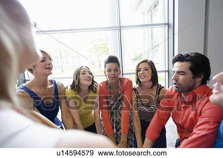 Business people cheering in office View Large Photo Image Stock Photo - Business people cheering in office. Fotosearch