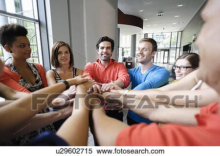 Business people cheering in office View Large Photo Image Stock Photography - Business people cheering in office. Fotosearch