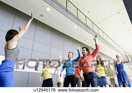 Business people dancing in office View Large Photo Image Stock Photo - Business people dancing in office. Fotosearch