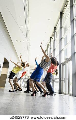 Business people dancing in office View Large Photo Image Stock Photograph - Business people dancing in office. Fotosearch