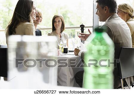 Stock Photo - Business people having lunch together. Fotosearch