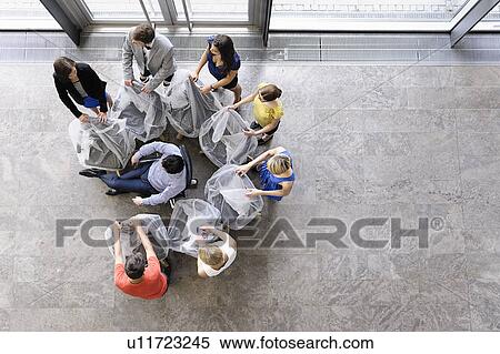 Stock Photography - Business people playing in new office. Fotosearch