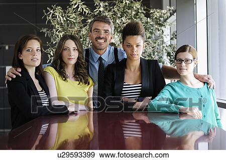 Business people smiling at table View Large Photo Image Stock Photo - Business people smiling at table. Fotosearch