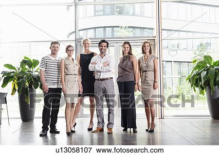 Business people smiling in office View Large Photo Image Stock Photo - Business people smiling in office. Fotosearch