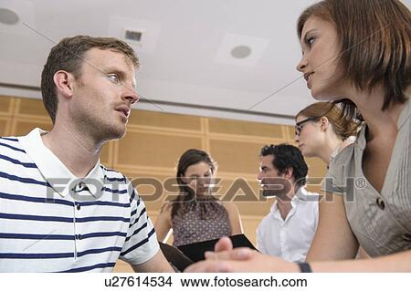 Picture - Business people talking in office. Fotosearch