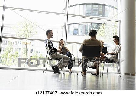 Stock Photo - Business people talking in office. Fotosearch