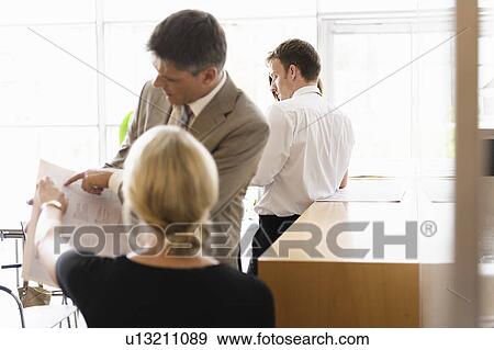Business people talking in office View Large Photo Image Stock Photo - Business people talking in office. Fotosearch