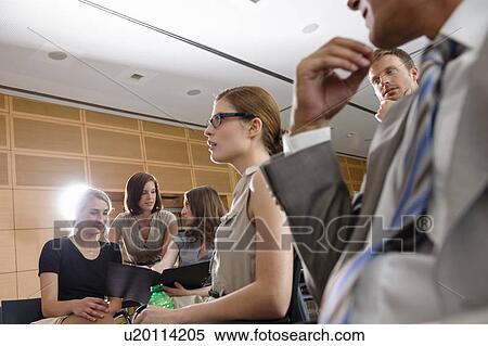 Stock Photography - Business people talking in office. Fotosearch