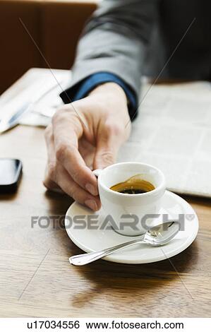 Stock Photograph - Businessman drinking cappuccino. Fotosearch