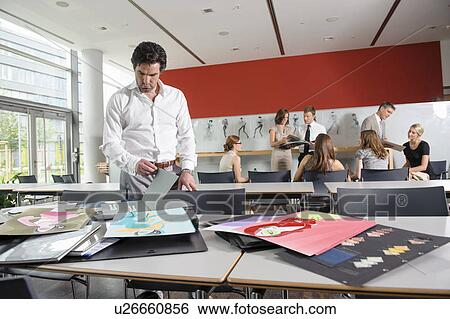Businessman examining fabric swatches View Large Photo Image Stock Photograph - Businessman examining fabric swatches. Fotosearch