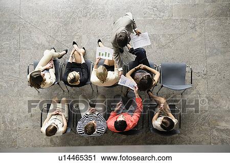 Businessman handing papers to colleagues View Large Photo Image Stock Image - Businessman handing papers to colleagues. Fotosearch