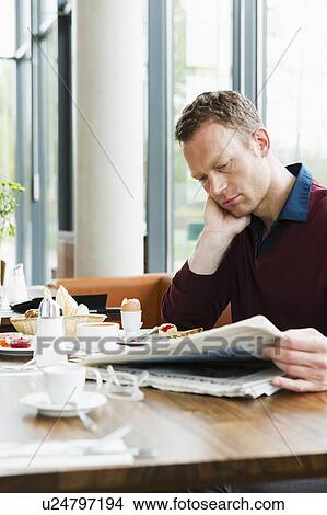 Businessman reading at breakfast View Large Photo Image Picture - Businessman reading at breakfast. Fotosearch