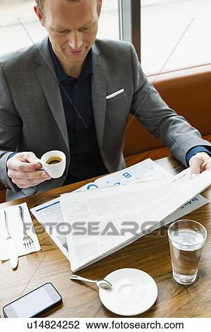 Businessman reading in cafe View Large Photo Image Stock Image - Businessman reading in cafe. Fotosearch