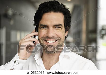Stock Photography - Businessman talking on cell phone. Fotosearch