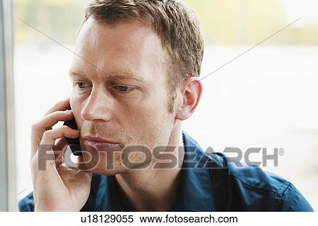 Stock Photography - Businessman talking on cell phone. Fotosearch