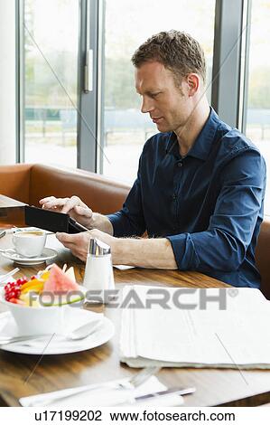 Businessman working in cafe View Large Photo Image Stock Image - Businessman working in cafe. Fotosearch